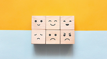 Image of different emotions on wooden cubes