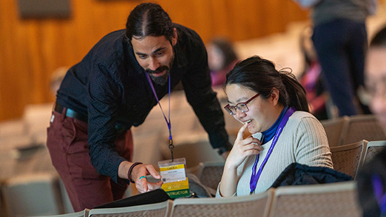 Man and woman looking at a computer