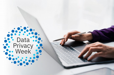 person typing on a laptop with the Data Privacy Week logo visable