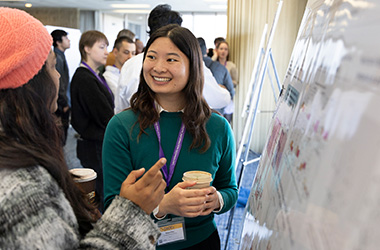 Student presenting a poster at the 2025 CoDEx symposium